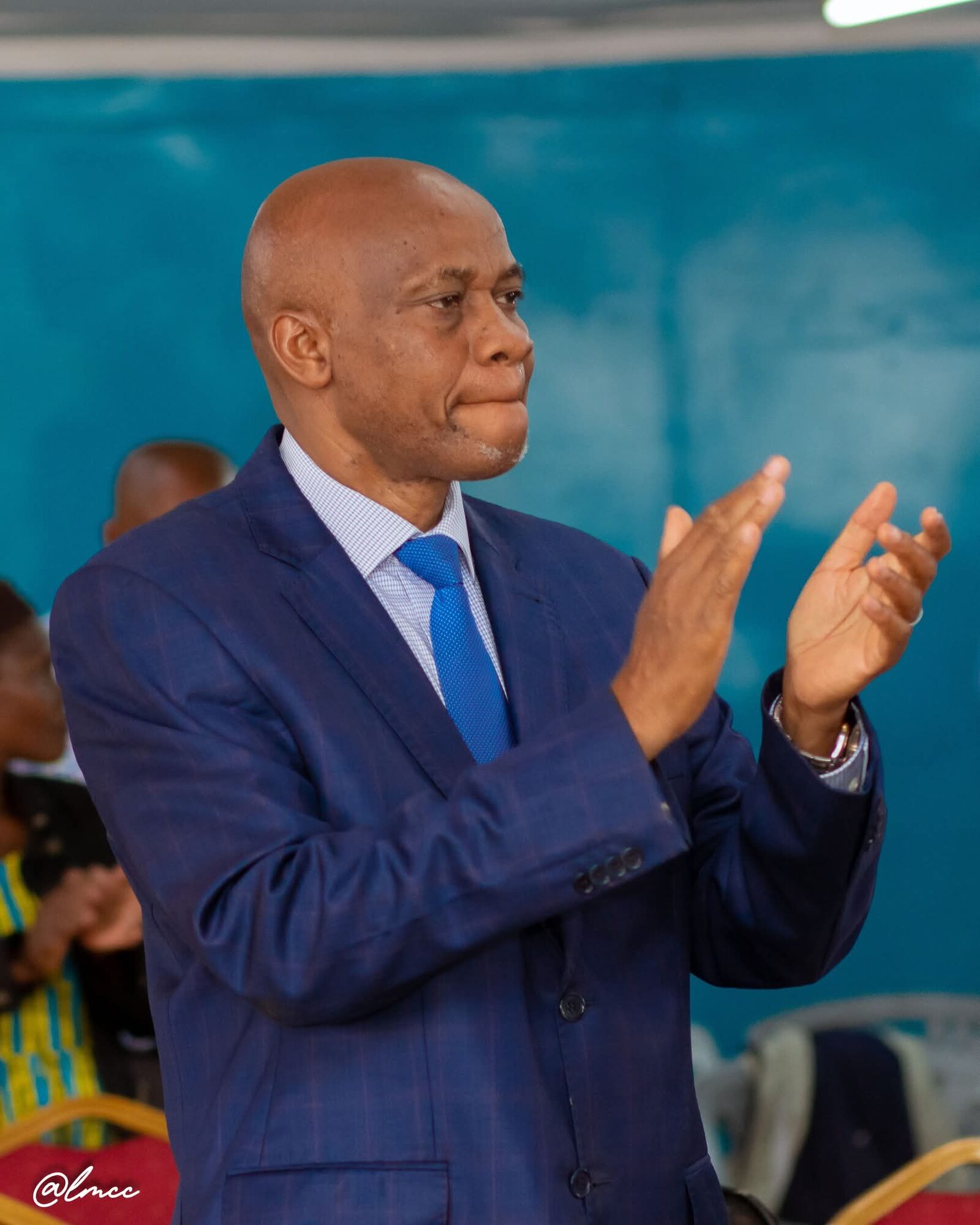 Bishop John Kaberere clapping during service