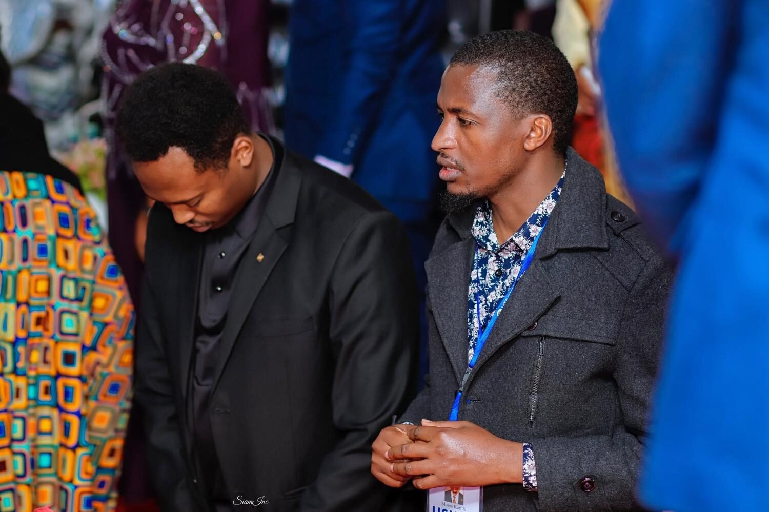 Two men standing side by side during service