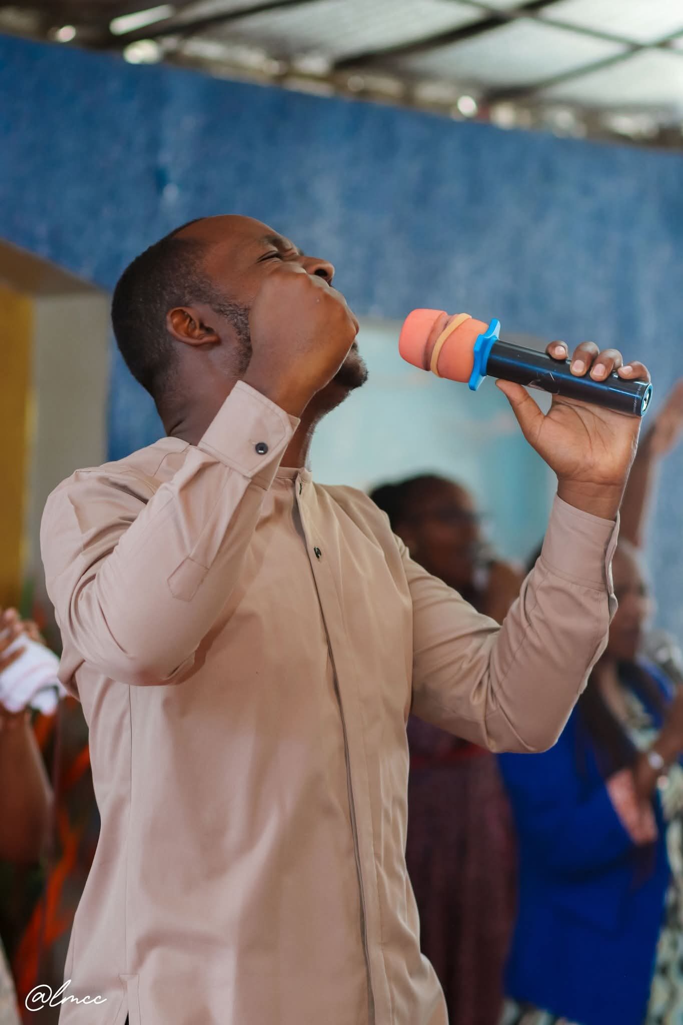 Minister singing passionately with microphone